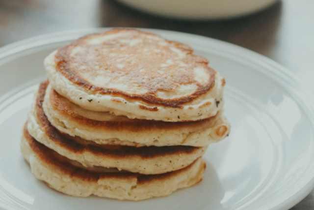 Homemade sourdough pancakes on a white plate